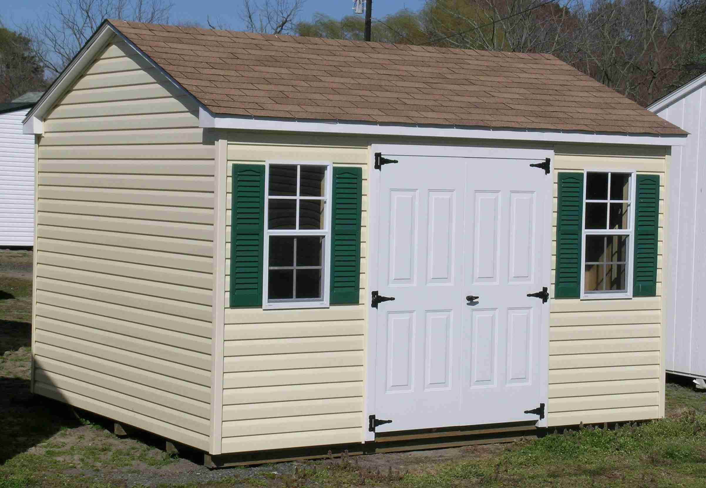 A-frame storage shed with yellow vinyl siding