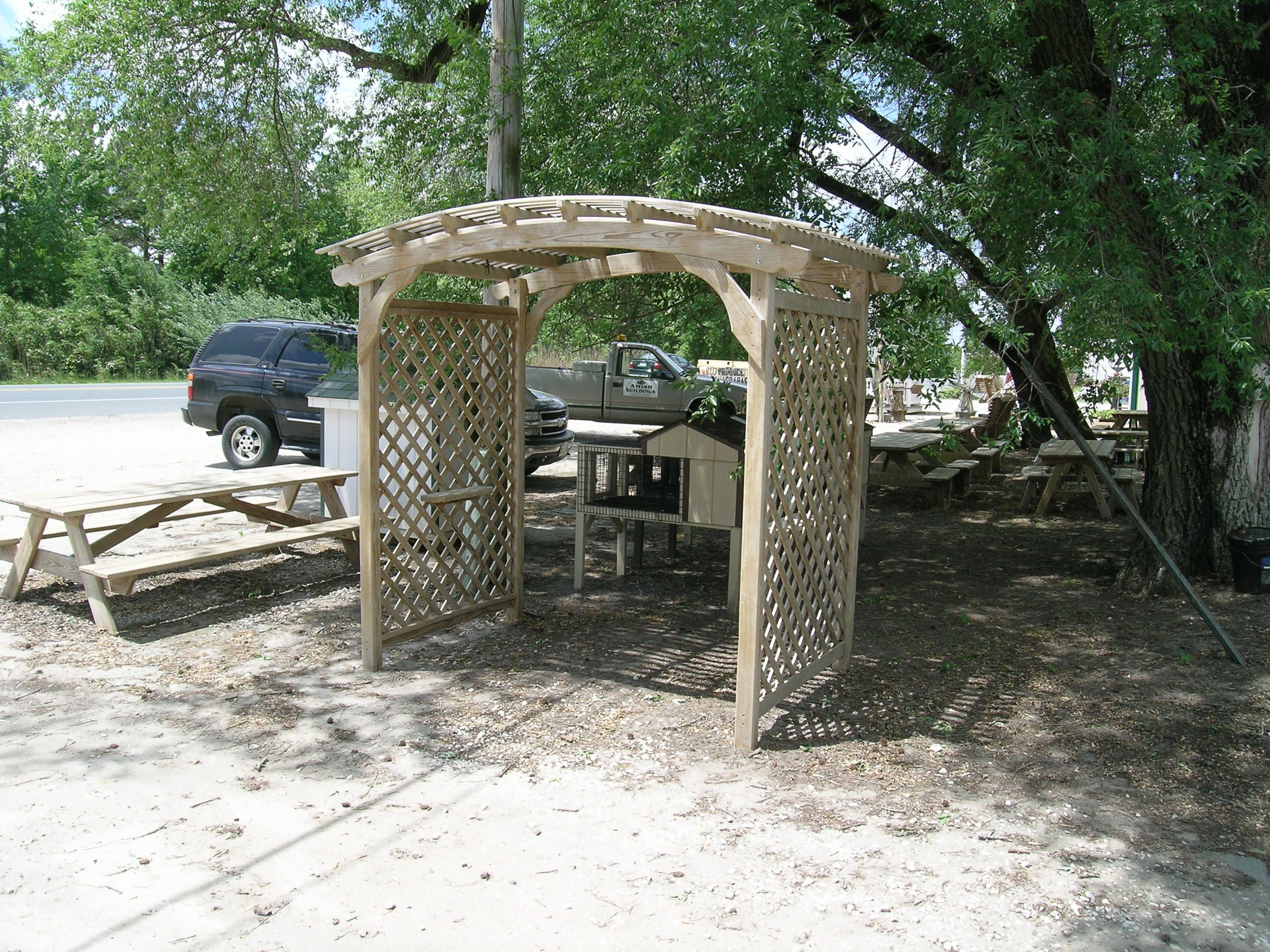 Large Arbor with Rabbit Hutch and Various Picnic Tables in the background