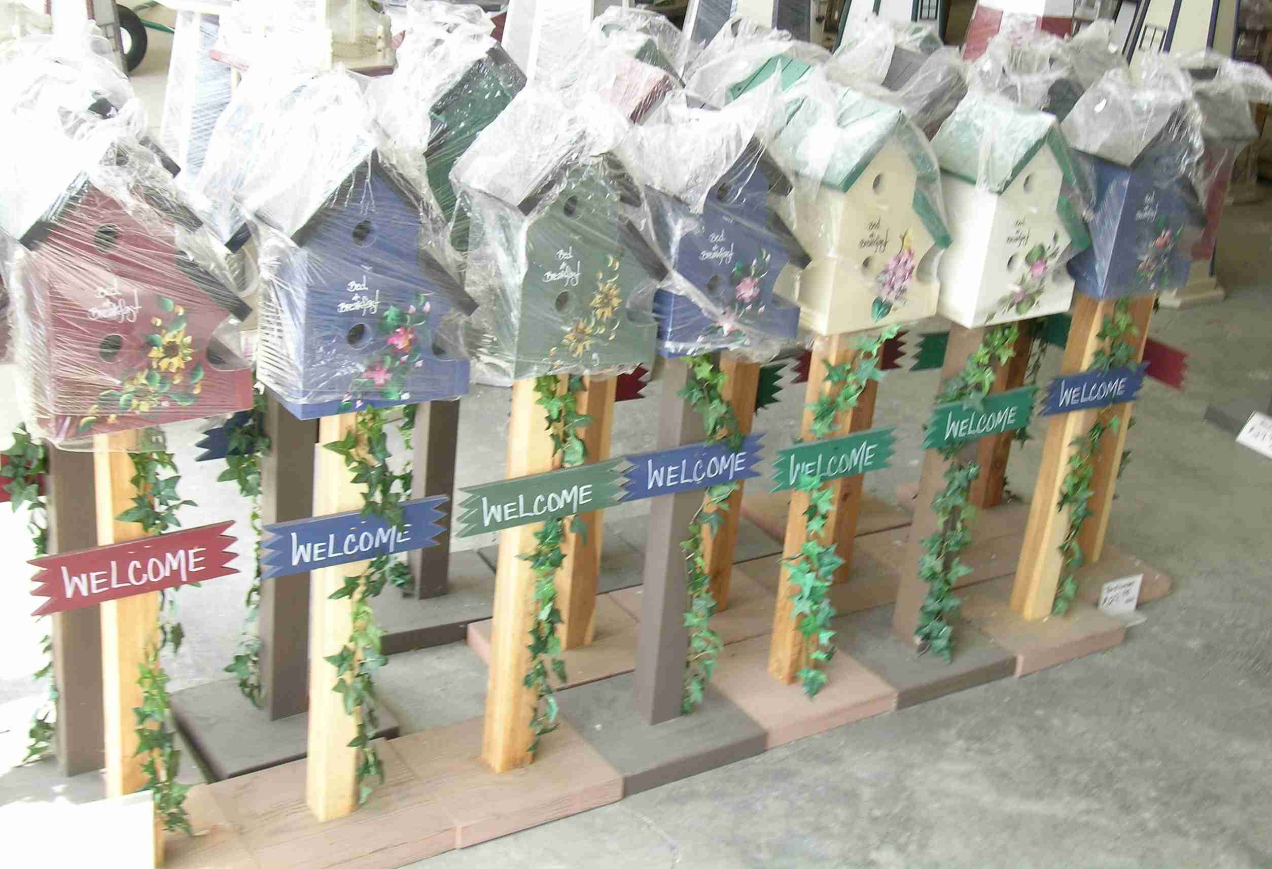 Several rows of birdhouses covered in plastic to keep the dust off