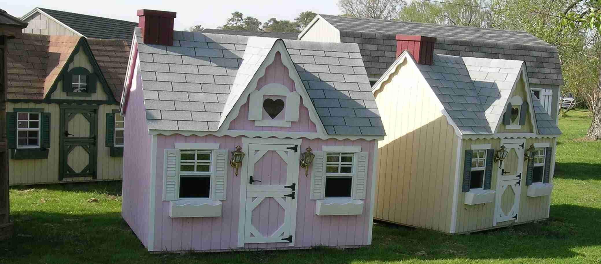 3 Victorian style playhouses with window boxes.
