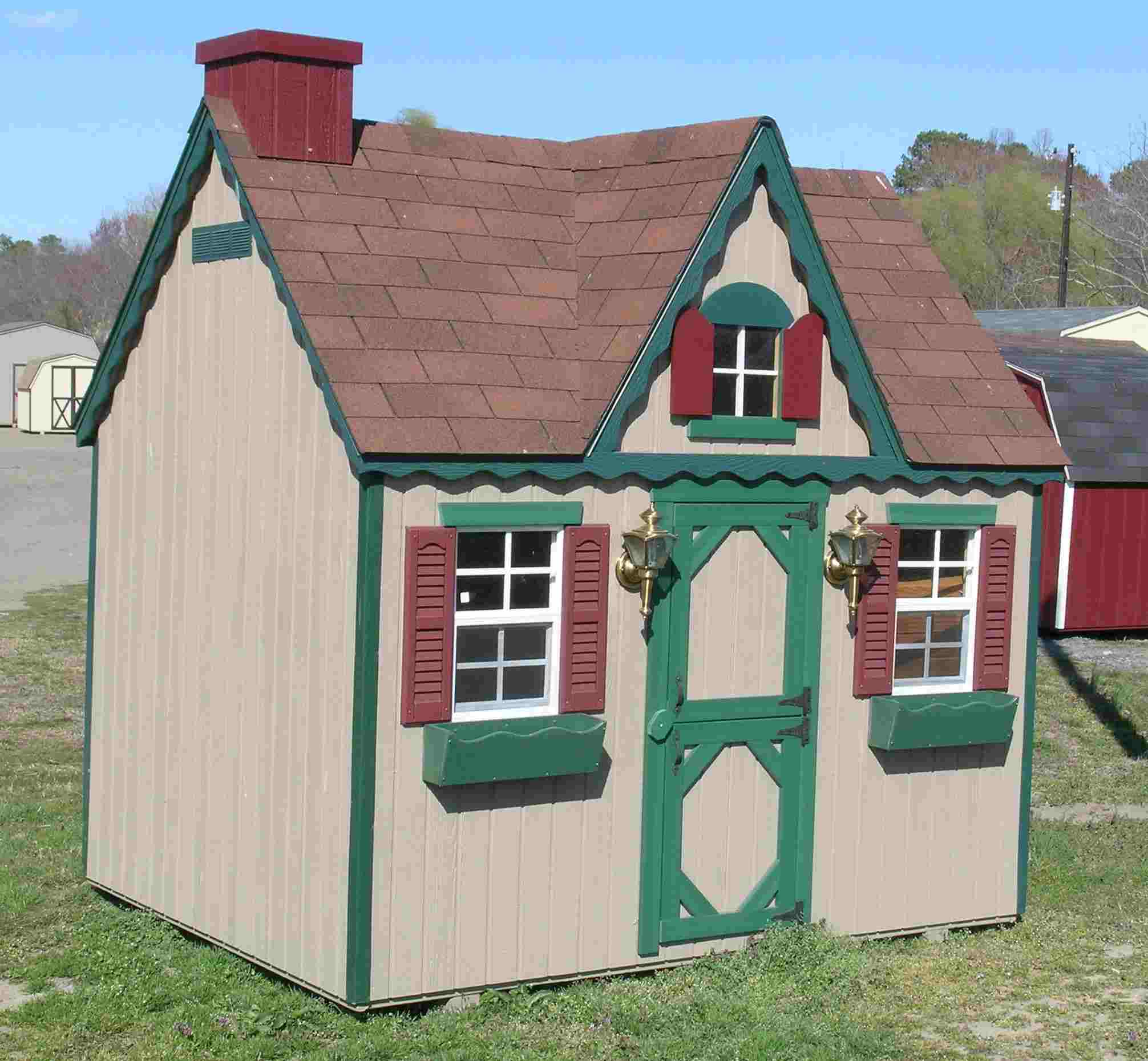 Victorian style playhouse with window boxes.